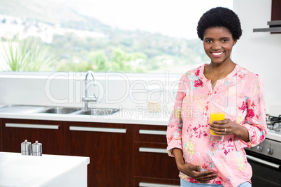 Pregnant woman drinking orange juice