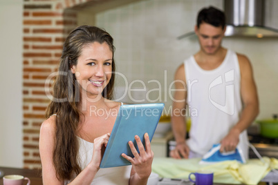 Portrait of woman using tablet in kitchen