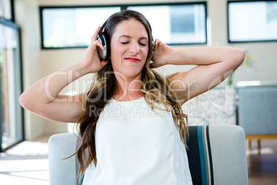 woman grimacing listening to headphone