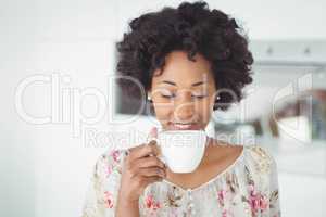 Peaceful woman holding white mug