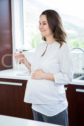Pregnant woman holding a glass of water