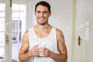 Portrait of young man holding a cup of tea