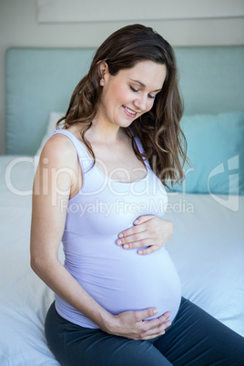 Pregnant woman touching her belly