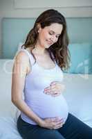 Pregnant woman touching her belly