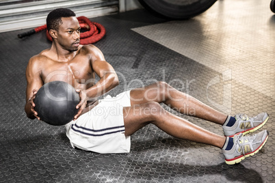 Muscular man training with medicine ball