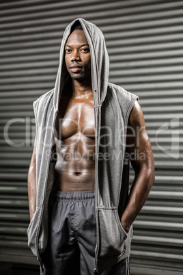 Standing shirtless man with grey jumper