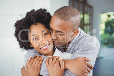 Happy couple hugging in the kitchen