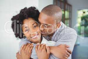 Happy couple hugging in the kitchen