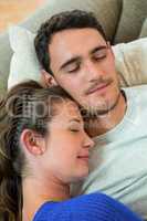 Young couple relaxing together on sofa