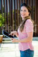 smiling woman scrolling on her tablet