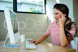 woman looking disgruntled sitting at her computer
