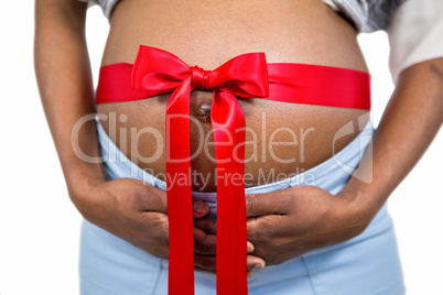 Pregnant woman with ribbon on bump