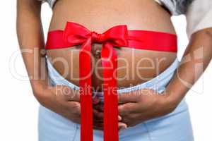 Pregnant woman with ribbon on bump