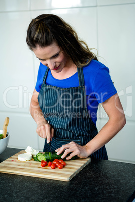 smiling woman preparing vegetables for dinner