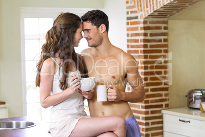 Young couple having breakfast in kitche