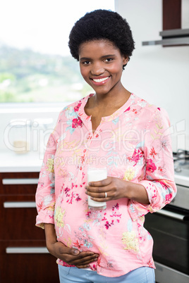 Pregnant woman drinking a glass of milk