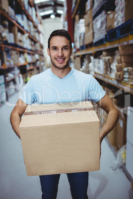 Smiling man holding big box