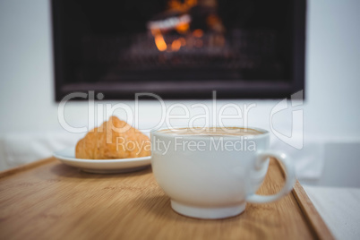 Coffee cup on table next to sweet food