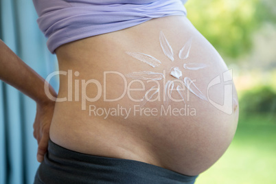 Pregnant woman with cream on her belly