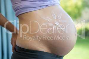 Pregnant woman with cream on her belly