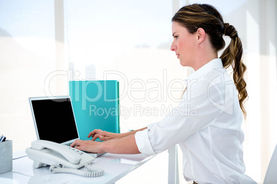 business woman typing on her laptop