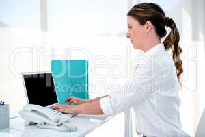 business woman typing on her laptop