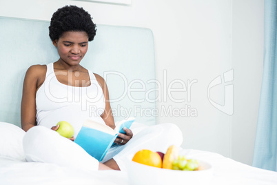 Pregnant woman reading a book