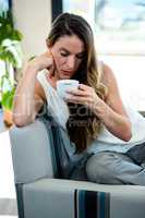 distracted woman, sipping a cup of coffee