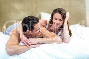 Smiling couple lying in bed