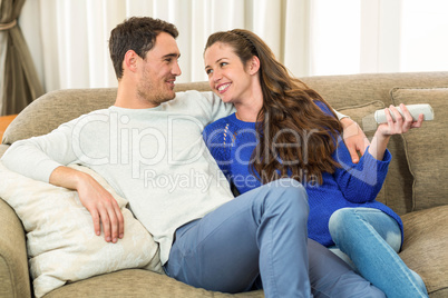 Young couple watching television together