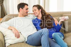 Young couple watching television together