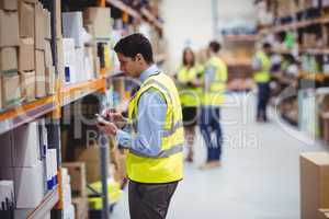 Warehouse worker using hand scanner