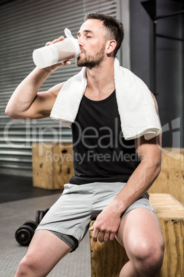 Muscular man drinking protein shake