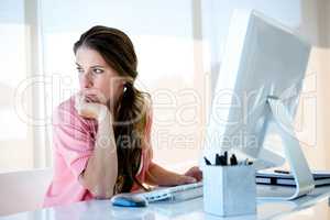 distracted business woman looking away from her computer