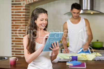 Woman using tablet in kitchen