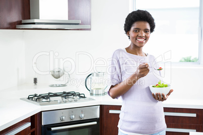 Pregnant woman eating salad