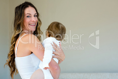 smiling woman holding a baby