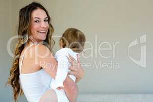 smiling woman holding a baby