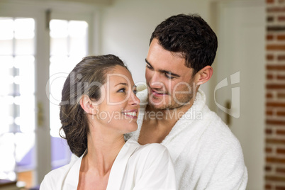 Couple in bathrobe embracing each other