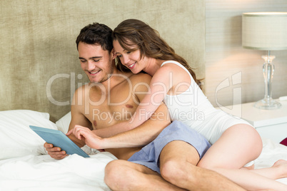 Young couple using digital tablet