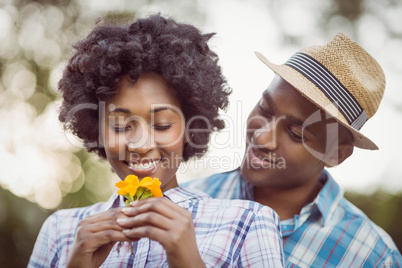 Smiling couple holding yellow flowers