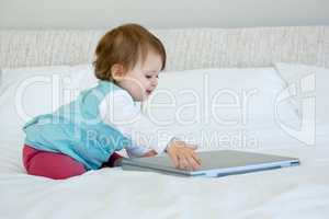 adorable baby playing with a laaptop