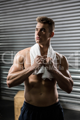 Shirtless man with towel around neck