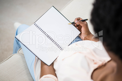 Pregnant woman holding notebook