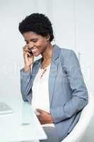 Pregnant businesswoman on the phone