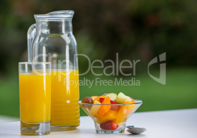 Bowl of fruit salad with orange juice