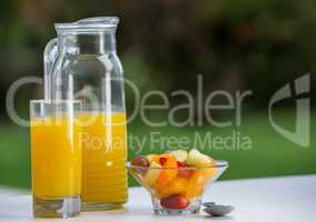 Bowl of fruit salad with orange juice