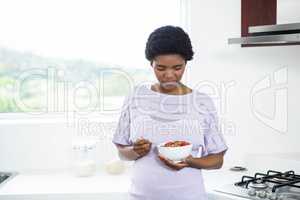 Pregnant woman eating cereal