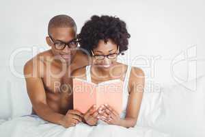 happy couple reading a book together