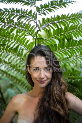 Portrait of beautiful woman standing outdoors in garden